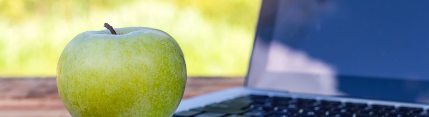 popular stocks like apple sitting on laptop