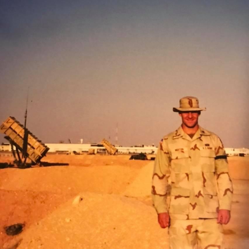 Dennis Morton in Army fatigues in the desert